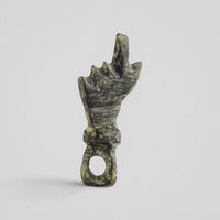Reverse of Roman bronze hand pendant Manicula, showing modelled wrist cuff and loop