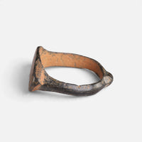Medieval bronze ring 'Rhombulus' shows its bezel edge and broad hoop from the opposite side.