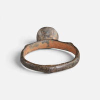 Byzantine bronze ring 'Monogrammos' shows the plain back of its round bezel and the inside of the hoop.