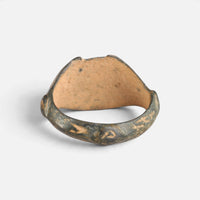 Medieval Islamic bronze ring 'Nasirun' shows the plain back of its bezel and the inner hoop.