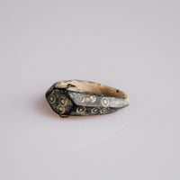 Roman bone ring Numerius held in gloved hand showing hoop silhouette