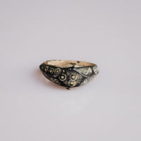Roman bone ring Numerius with ring-and-dot ocelli decoration on faceted bezel