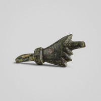 Roman bronze hand amulet Manicula in profile, showing folded fingers and collared wrist