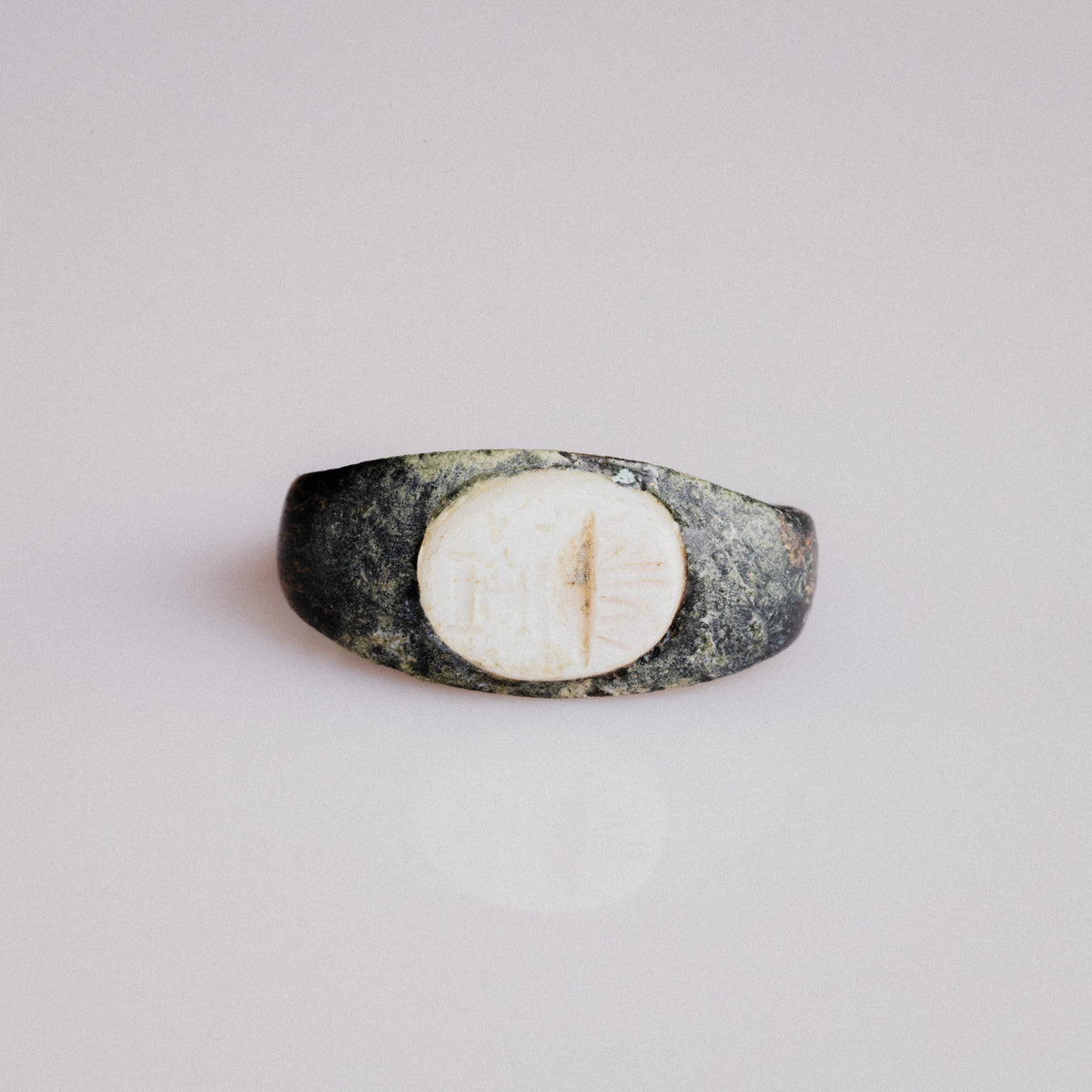 Roman bronze intaglio ring Numerius with white stone bezel and altar motif, top view