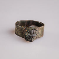 Roman bronze lion-head ring Leontios, front view of the sculpted bezel with malachite patina