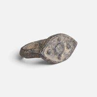 Roman bronze ring 'Cassia' shows its circular bezel decoration and broad shoulder at an angle.