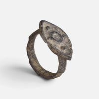 Roman bronze ring 'Cassia' shows its decorated navette bezel and complete hoop at an angle.