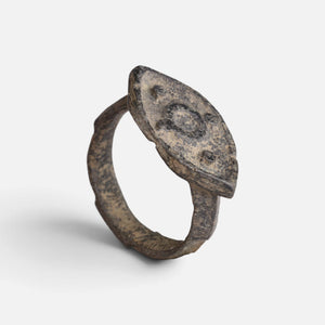 Roman bronze ring 'Cassia' shows its decorated navette bezel and complete hoop at an angle.