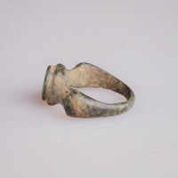 Roman bronze ring Corvidus angled view with shoulder knobs flanking the engraved bezel