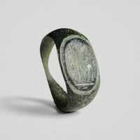 Roman bronze ring Equinor, three-quarter view showing raised oval bezel with horse and rider in relief