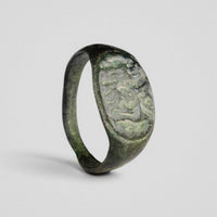 Roman bronze ring Equirius shown upright with equestrian relief bezel and green patina