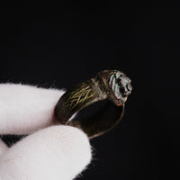 Roman bronze ring Leontios held in gloved hand, showing scale and mane detail