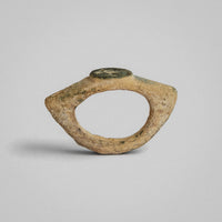 Roman bronze ring Verecundus, side profile showing the disc bezel above flaring shoulders and the hoop