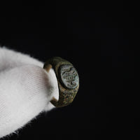 Roman bronze ring Numerius held in hand showing scale and stratified patina