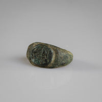 Roman bronze ring Numerius rotated to show flanking marks beside the bird figure