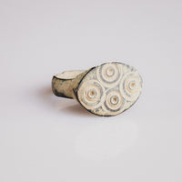 Roman bronze ring Numerius showing engraved oval bezel and tapering D-section hoop