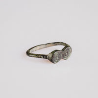 Roman bronze ring Numerius shown at three-quarter angle revealing twin disc bezel