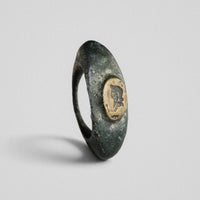 Roman bronze ring Vultinus, three-quarter view showing raised oval bezel with engraved profile bust