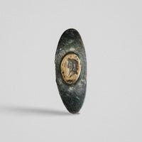 Roman bronze ring Vultinus, top-down view of oval bezel with intaglio profile bust