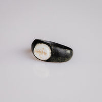 Roman bronze ring Velthur, angled overhead view of intaglio bezel and shoulders