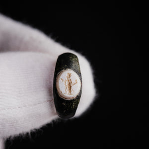 Roman bronze ring Velthur, detailed macro of engraved Mercury figure on chalcedony stone