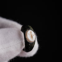 Roman bronze ring Velthur, macro close-up of Mercury intaglio with petasos, caduceus and purse