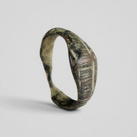 Roman bronze ring Vindex, three-quarter view showing keeled shoulders and hatched panel