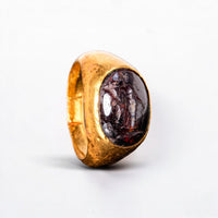 Roman gold ring with garnet intaglio of Fortuna, angled view