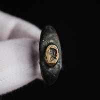 Roman bronze ring Vultinus, close view of the worn engraved profile bust on the bezel