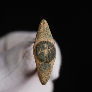 Roman bronze ring Verecundus held in a gloved hand, front view of the standing figure on the bezel