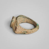 Side view of Roman bronze ring 'Tullia' showing a flat triangular shoulder facet and the disc bezel in profile