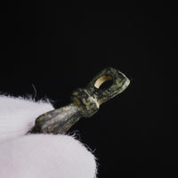 Roman bronze hand pendant 'Manicula' upright with its suspension loop, held between gloved fingers