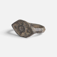 Roman bronze ring 'Cassia' shows its circular bezel decoration from the opposite front angle.