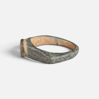Roman bronze ring 'Aquilarius' shows its bezel edge and broad hoop from the opposite side.