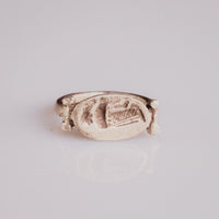 Roman silver ring Numeria showing oval intaglio bezel engraved with a standing draped figure, top view