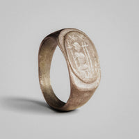 Roman silver signet-form ring Solaris with raised oval bezel showing a figural device in relief