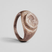 Roman silver signet ring Galerius with raised oval bezel and intaglio helmet device, three-quarter view
