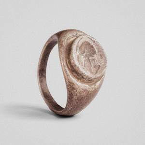 Roman silver signet ring Galerius with raised oval bezel and intaglio helmet device, three-quarter view