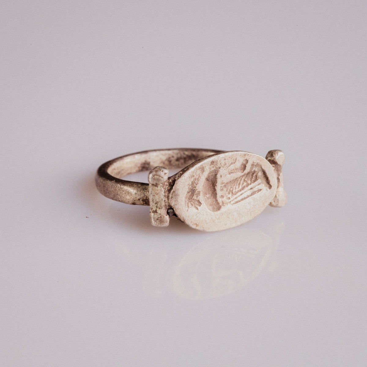 Roman silver swivel-bezel signet ring Numeria with intaglio of a draped female figure, three-quarter view