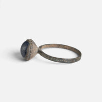 Byzantine bronze ring 'Kaloira' shows its blue setting and thin hoop from the opposite side.