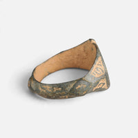 Medieval Islamic bronze ring 'Nasirun' shows the inside of its broad shoulders and the back of the hoop.