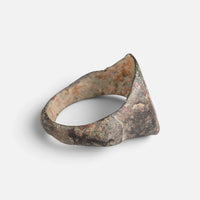 Medieval Islamic bronze ring 'Tahir' shows its broad inner shoulder and the back of the hoop at an angle.