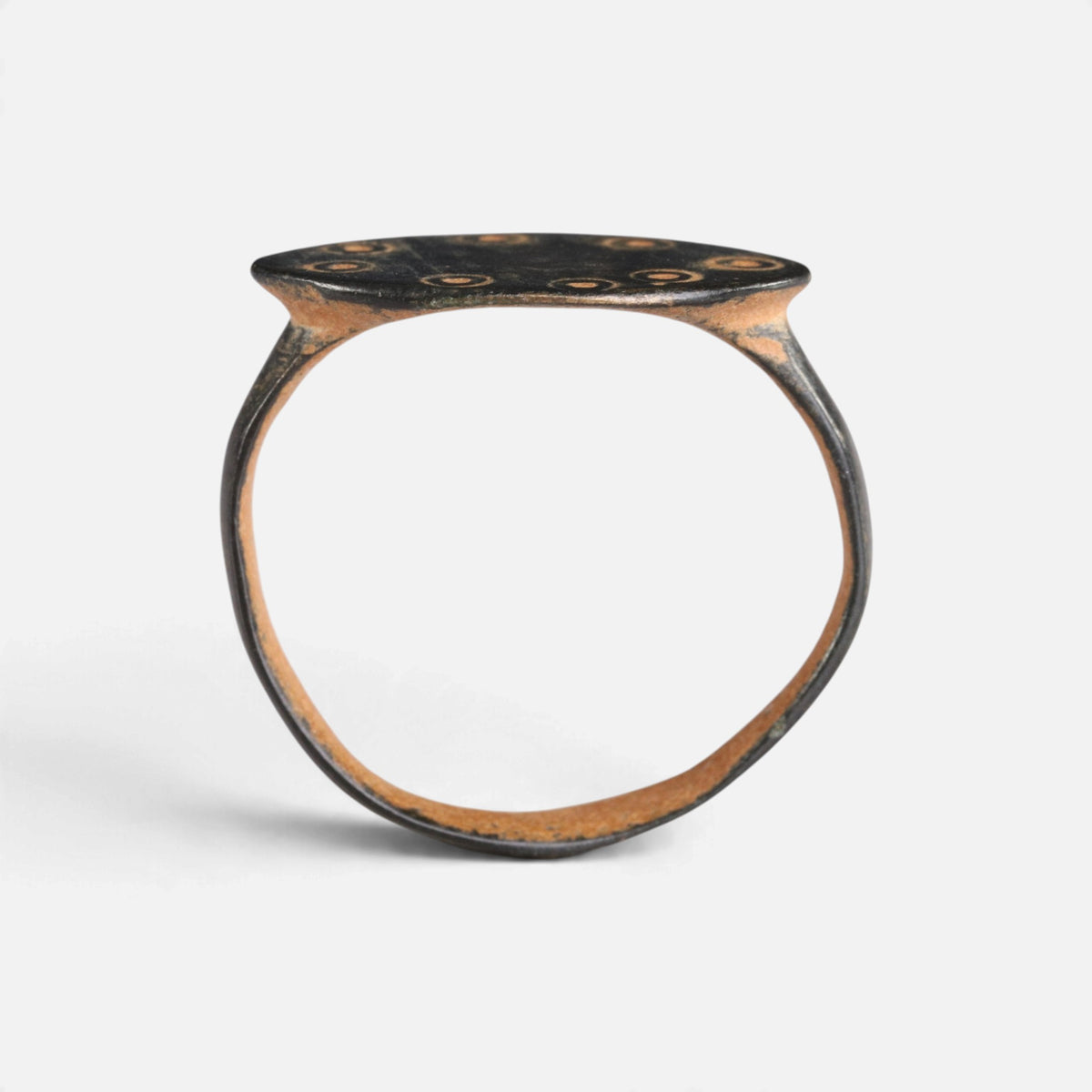 Byzantine bronze ring 'Okellina' shows its complete hoop and the thin oval bezel edge in profile.