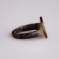 Side profile of Byzantine bronze ring Stellaris showing tapering shoulders and worn bronze hoop
