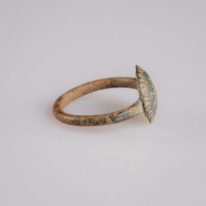 Side profile of Byzantine bronze ring Theodora showing domed bezel and rayed border