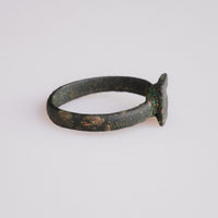 Side profile of Byzantine bronze ring Zosimos revealing thin D-section hoop and patina