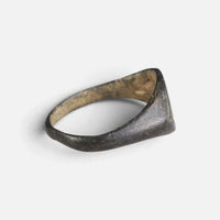 Medieval bronze ring 'Aldhelm' shows the back of its hoop and broad inner shoulder at an angle.