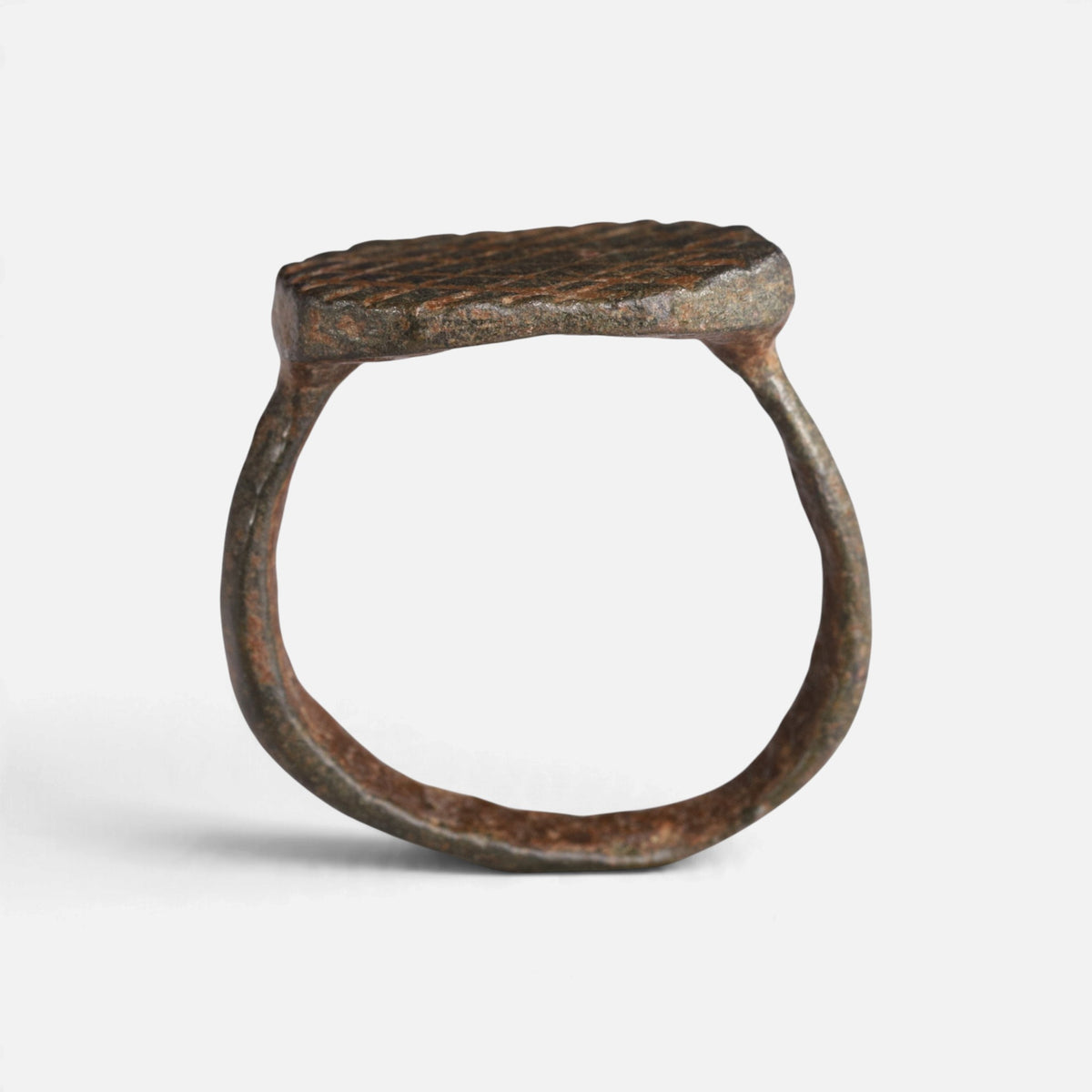 Medieval bronze ring 'Anselm' shows its complete hoop and octagonal bezel edge in profile.