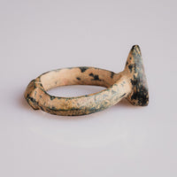 Side profile of medieval bronze ring Zvezdan showing plain hoop and projecting teardrop bezel