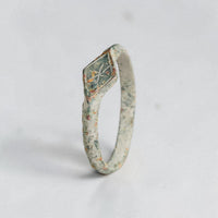 Side profile of medieval bronze signet ring Stellira with malachite green patina and cuprite red spots